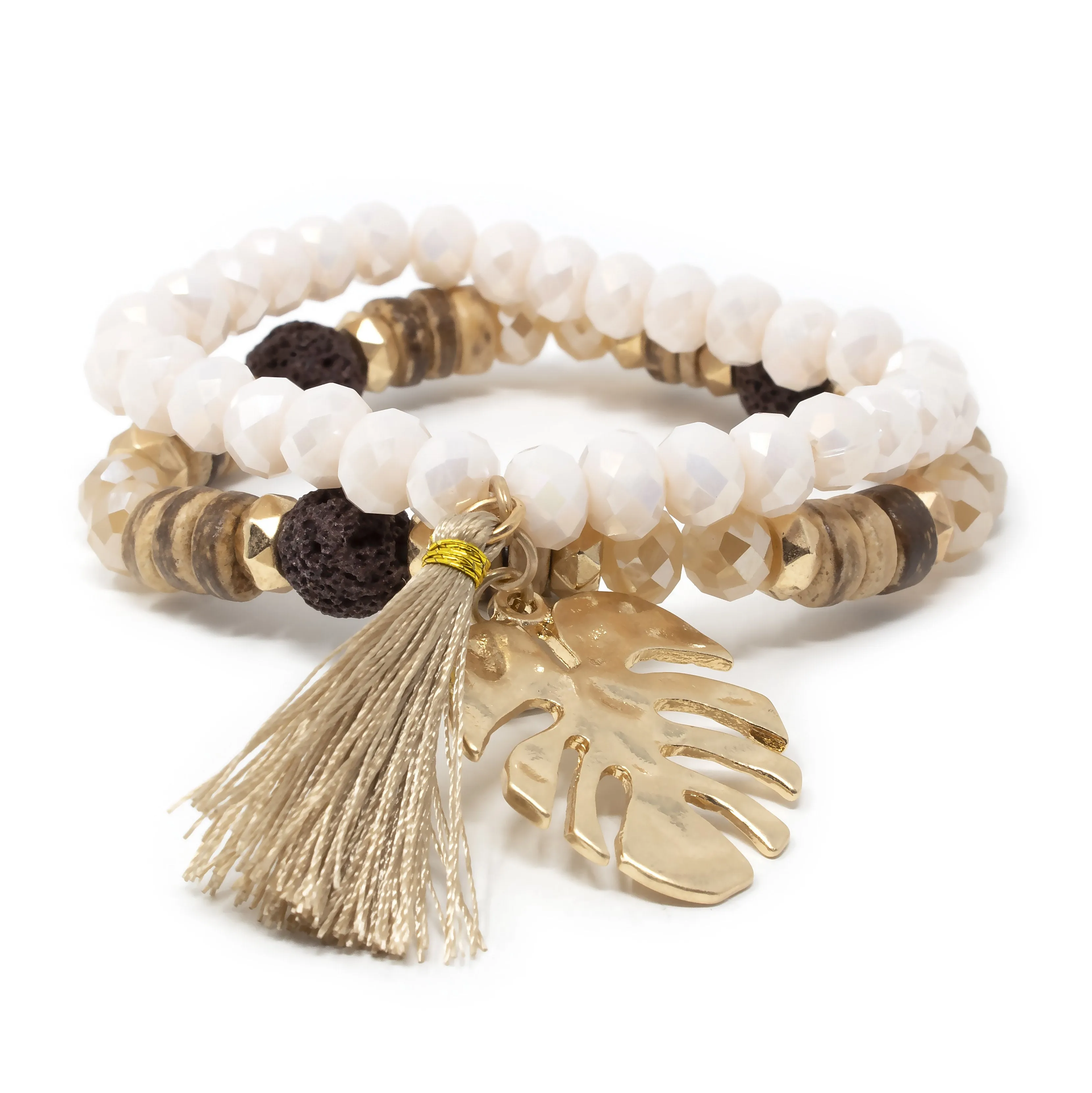 Gold Tone Set of Two Stretch Bracelets With Tassel and Leaf Charm Cream