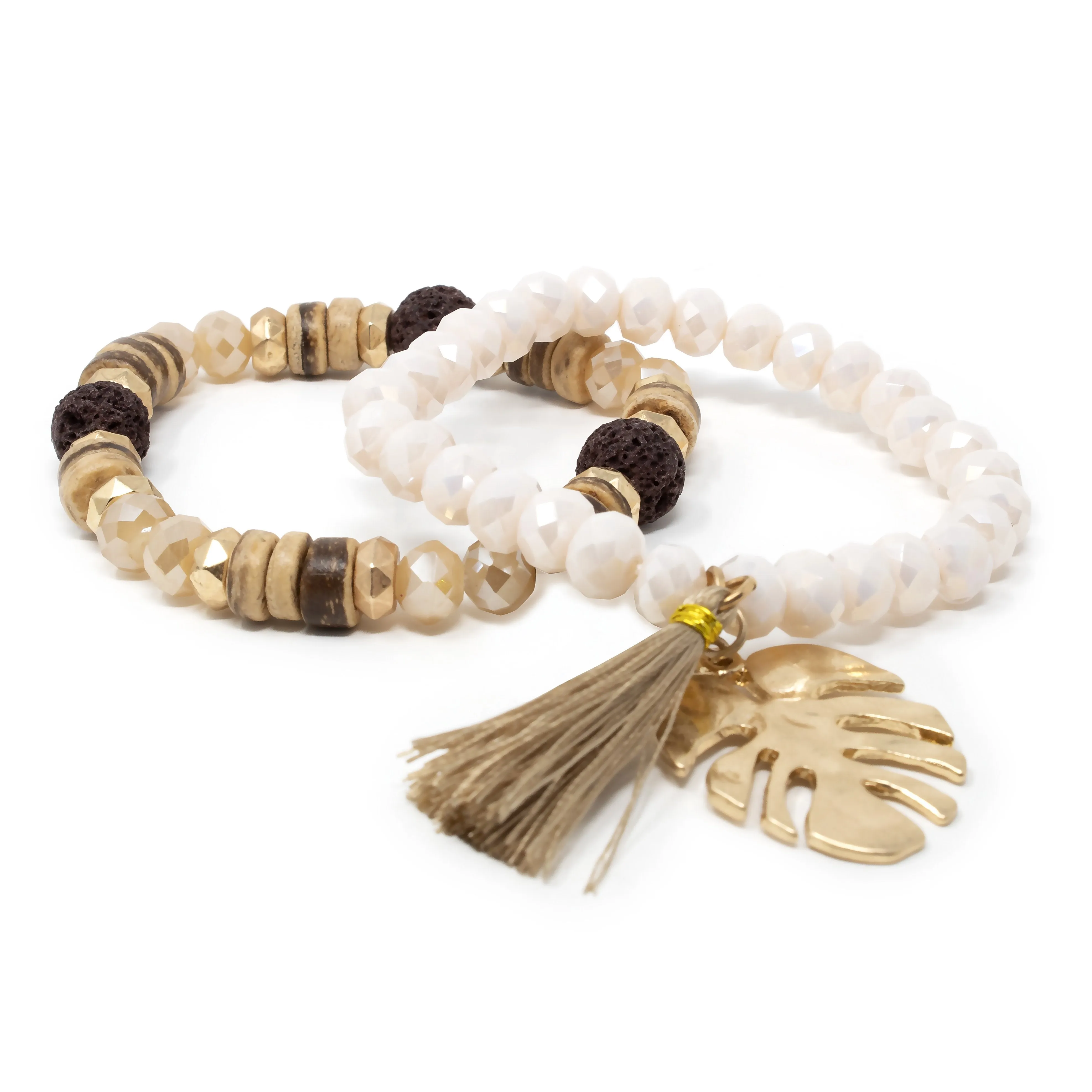 Gold Tone Set of Two Stretch Bracelets With Tassel and Leaf Charm Cream